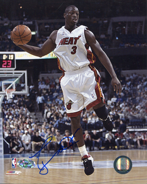 Dwyane Wade Autographed Passing Rookie 8x10 Photo. Signed in blue sharpie across the front of the photo. Authenticity is provided by Rich Altman's Hollywood Collectibles and will be accompanied with a COA from Hollywood Collectibles.